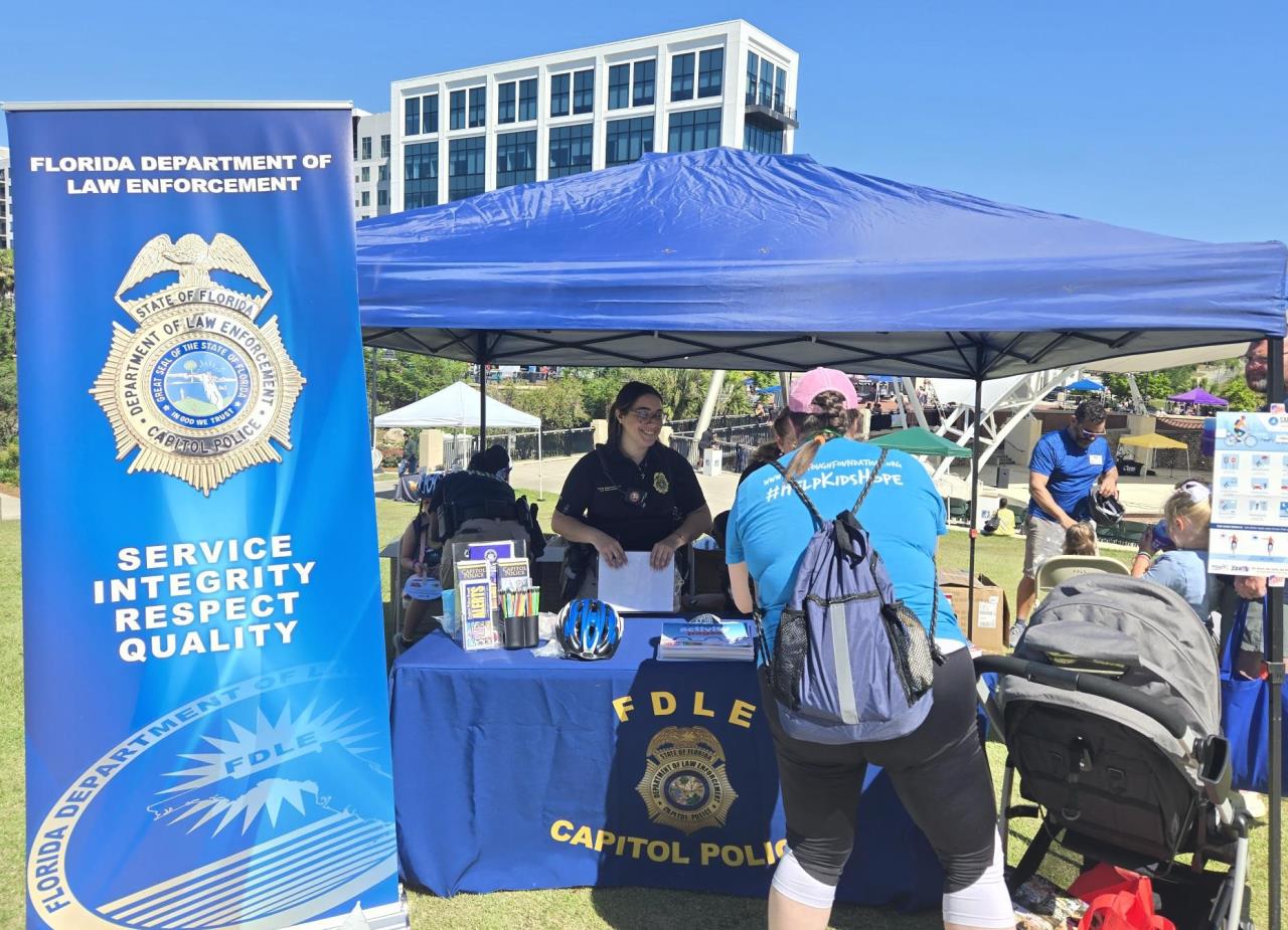 CP officer with crime prevention at a community event.